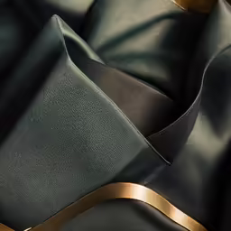 dark blue, black, gold - plated fabric with an irregular look