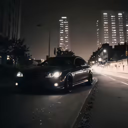 a car is driving through the city at night