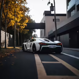 a white sports car is parked on the side of the street