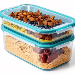 two food containers one has blueberries, brown and yellow rice