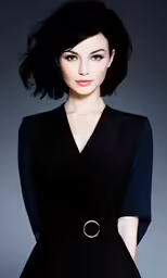 a woman in a black dress poses for the camera