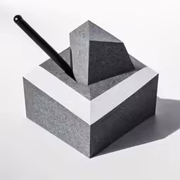 a small grey container with a pen on top