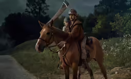 a couple riding on the back of horses