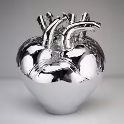 a sculpture of an apple with several metallic handles