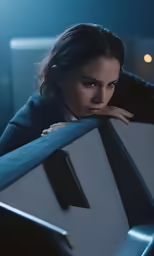 a woman is leaning against a bench with her arms on it