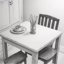 a black and white image of a table with an empty plate
