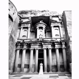 a beautiful bride poses in front of a building