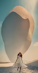 a woman in white holding her arms out in front of a large object