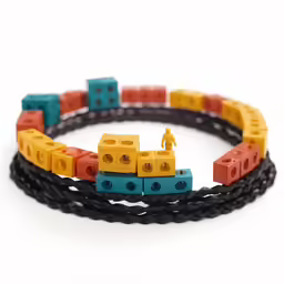 a set of four bracelets made of lego blocks with one smaller toy in front