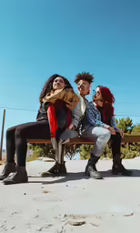 four friends are sitting on a park bench
