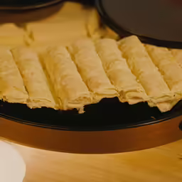 a pan with rolled pasties on top of it
