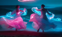 two young women are performing a light show