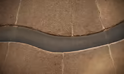 a river flowing down side of a stone wall