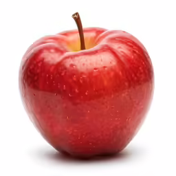 an apple with water droplets is in a light spot