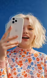 a woman with blonde hair holding up her phone