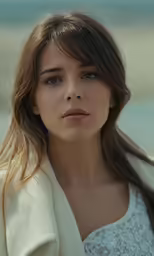 a beautiful young woman in white posing for the camera