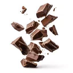 a chocolate bar is falling into pieces and being tossed by an ice cream cream flavor