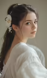 a woman with long hair wearing a flower in her hair