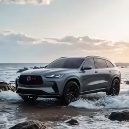 the front end of a silver and black volvo vehicle driving through rough water