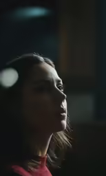 a woman with a tie in the dark