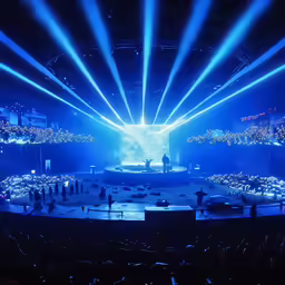 a view of an outdoor concert with bright beams