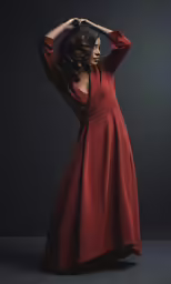 a woman in a red dress posing for the camera