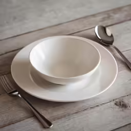 a white plate topped with two white bowls