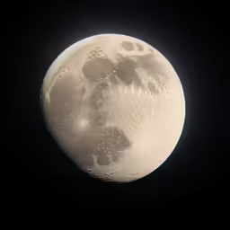 a white moon with black background and a light colored spot