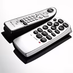 a couple of remotes are sitting on a table