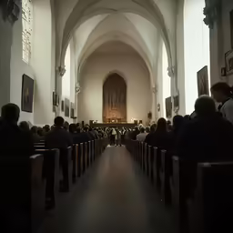 an image of people in church looking at the alter