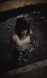 a young woman standing in the water