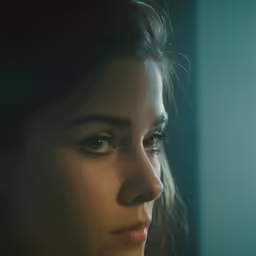 a woman in profile looking out the window