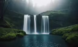 a beautiful waterfalls scene with fog in the sky