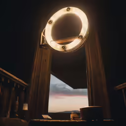 a circular light hanging above a railing near a window