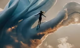 the figure is riding on the top of a blue wave
