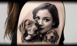 a person with two dogs next to their face