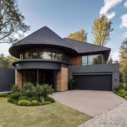 an elegant, modern looking home with a black roof and brick facade