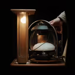 a person is holding a light with an object