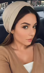 a woman sitting in the drivers seat of a car