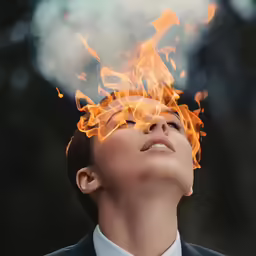 a woman in a suit with fire in her hair