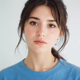 a woman in a blue shirt is staring into the camera