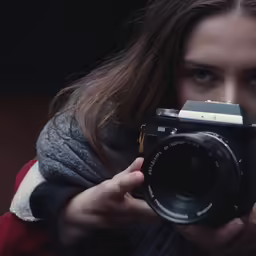 a girl taking pictures with a digital camera