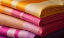 some colorful sheets stacked on top of each other