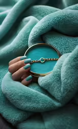 the ring is resting on a turquoise blanket