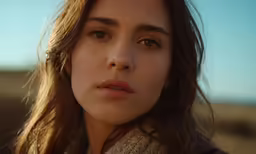 the woman is looking at something while staring
