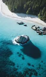 a group of large rocks in water next to shore