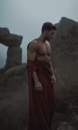a man standing on a rocky mountain next to rocks