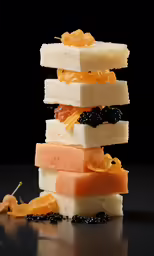 a stack of different types of fruits and candy