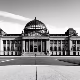 the dome of an old building stands out in front of a dark, dreary sky