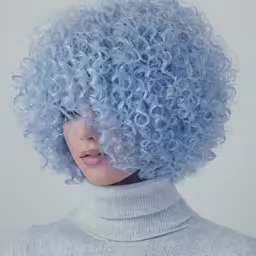 a blue haired woman has curly hair